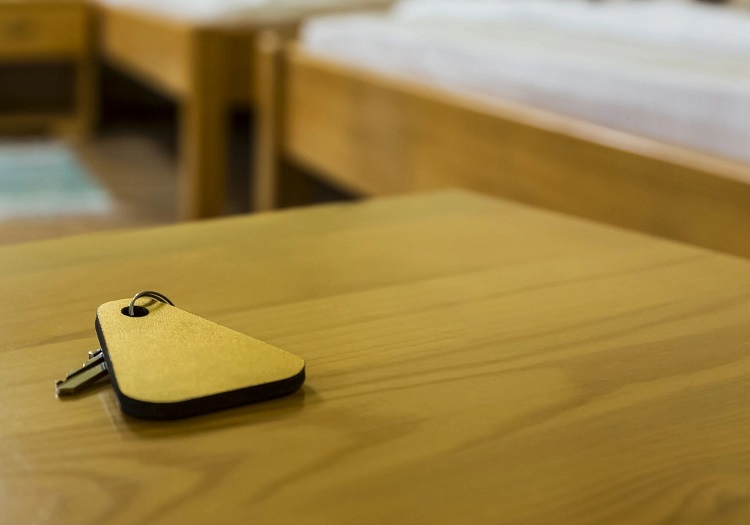 a hotel key on a wooden table